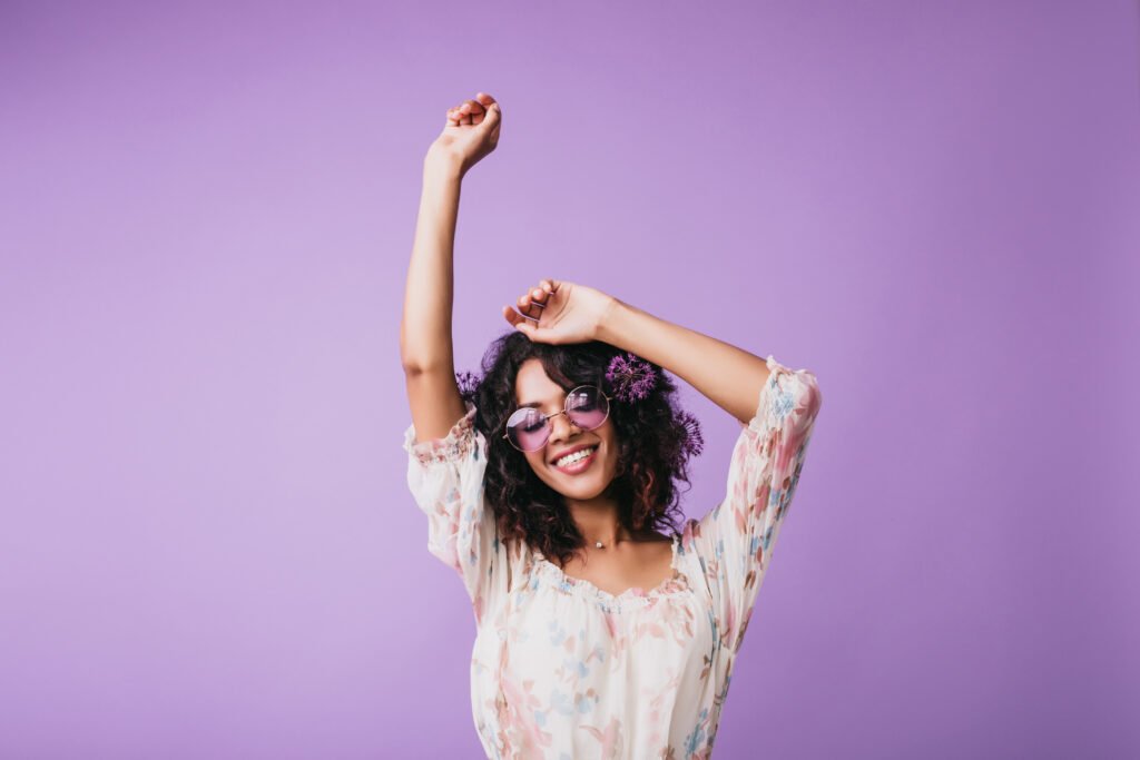 Indoor portrait of magnificent african woman standing on purple